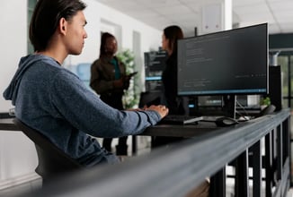 web developer monitoring a website on a computer as part of website security and cyberattack prevention